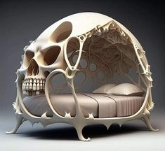 a white bed with a skull head on it's side and an intricately designed frame