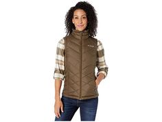 Columbia Heavenly Vest - Women's Vest : Olive Green : The Columbia Heavenly Vest is a lightweight and comfy vest that's perfect on its own or for when you need to add a little bit more warmth with your layering. Omni-Heat reflective lining • Metallic lining reflects body-generated heat for improved warmth retention. • Backing dissipates excess heat. • Membrane comprises 65% of lining for high breathability. Constructed with a water-resistant shell. Plush lined stand collar for maximum comfort. S Puffer Vests, Womens Puffer Vest, Green Vest, Vest Women, Skirt And Blouse, Puffer Vest, Women's Vest, Womens Vest, Stand Collar