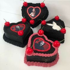 four heart shaped cakes with cherries on them and one has a photo in the middle