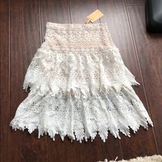 Nwt! Champagne And Strawberry Skirt Size Small. Beautiful Crochet Lace Detail All Around This Tier Skirt. White With A Mini Nude Underlining Skirt. Hidden Side Zipper. 100% Polyester. Front Length 25” Waist 14”. Any Questions Please Ask. ***If This Item Meets Your Expectations Please Rate Me Thanks *** White Lace Mini Skirt With Ruffles, White Fitted Lace Mini Skirt, White Ruffled Lace Skirt, White Tiered Mini Skirt With Lace Trim, Fitted White Skirt With Lace Trim, White Lace Knee-length Skirt, White Ruffled Mini Skirt For Brunch, Bohemian White Mini Skirt With Lace Trim, White Midi Skirt With Lace Trim