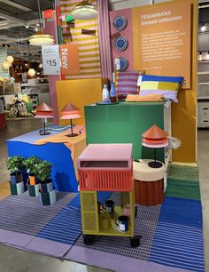 an exhibit with colorful furniture and lamps on display