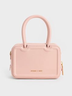 This product is made with at least 20% sustainable materials by weight. CHARLES & KEITH uses recycled, degradable, organic, and water-based materials in our eco-conscious collection.If a dainty, polished carrier is what you are looking for, then the Perline tote is your best bet. The angular boxy shape is softened by the charming pink finish, creating a minimalist yet unmistakably feminine silhouette. Affixed with classic top handles, the structured carrier is elevated enough for evening functio Charles And Keith Bags, Charles And Keith, Brand Name Bags, Luxury Bags Collection, Size Chart For Kids, Airport Fashion, Charles Keith, Handle Bag, Belt Size