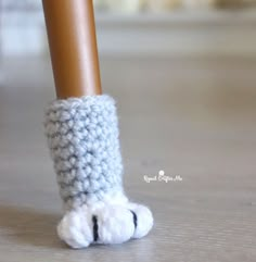 a close up of a person's feet wearing crocheted slippers and socks