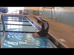 a woman is sitting on the edge of a swimming pool and stretching her legs out