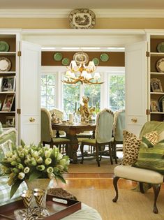 a formal dining room with green and white decor