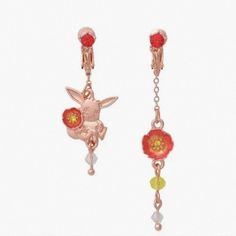 a pair of red and yellow earrings with flowers on it's ear ends, hanging from a chain