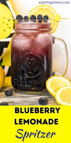 blueberry lemonade spritzer in a mason jar surrounded by lemons and blackberries