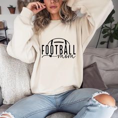 Introducing the perfect sweatshirt for every proud football mom! This cozy and stylish football mom sweatshirt is designed for comfort and team spirit. Made from a soft, high-quality cotton blend, it offers a relaxed fit that's ideal for those chilly game days. This sweatshirt is a must-have for any football mom who loves cheering on her favorite player in style! The Gildan 18000 Crewneck is a go-to choice for comfort and style. Crafted from premium cotton, it provides a soft and cozy feel. With Relaxed Fit Sweatshirt For Sports Events In Fall, Relaxed Fit Sweatshirt For Game Day In Fall, Casual White Sweatshirt For Football Season, Relaxed Fit Sweatshirt For College Football Season, Football Season Relaxed Fit Sweatshirt For Sports Events, Relaxed Fit Sweatshirt For Football Season, Casual Sweatshirt For Football Season, Casual Sweatshirt For Sports During Football Season, Game Day Casual Soft-washed Sweatshirt