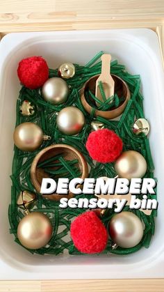 a box filled with christmas ornaments on top of a wooden table