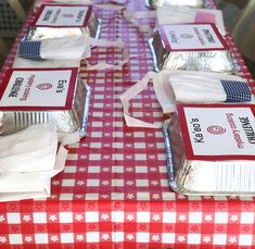 the table is covered with red, white and blue paper napkins that are wrapped in silver foil