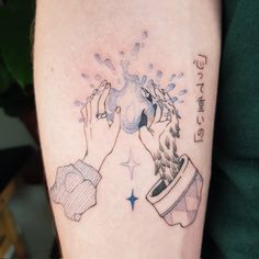 a woman's arm with a tattoo on it that has water coming out of the cup