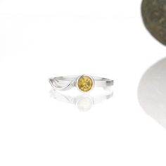 A wave of sterling silver rises up out of the base of a sparkling gemstone, and tumbles in a tiny rivulet down the side of the band. The 5mm Cascade ring is flashier than its daintier sisters, but still has a slender band designed to nestle closely with one or more accompanying rings. This sparkly citrine and sterling silver ring is handcrafted and made to order. Wear it by itself, or customize a stack of skinny bands and coordinating gemstone rings - the possibilities to mix and match are endle Sterling Silver Jewelry With Tension Setting In Round Band, Modern Sterling Silver Birthstone Ring For Promise, Modern Twist Sterling Silver Promise Jewelry, Fine Jewelry Silver Yellow Sapphire Jewelry, Fine Jewelry: Silver Yellow Sapphire, Modern Sterling Silver Stackable Rings With Tension Setting, Silver Jewelry With Yellow Sapphire For Anniversary, Silver Yellow Sapphire Jewelry For Anniversary, Promise Birthstone Ring With Tension Setting In Sterling Silver