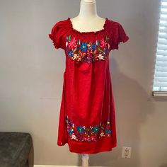 Artisanal Mexican Beautiful Dress Size L Color Red Whit Embroidered Flower Colors Of The Flowers Are Hot Pink, Purple. White, And Royal Blue.Elastic Collar Short Sleeves Whit Elastic To.Material 100% Blanket Fabric ( Tela De Manta) Measures Are 34” Longer And 24.5 “ Wider New No Tags. Folk Style Short Sleeve Dress For Fiesta, Traditional Red Embroidered Spring Dress, Traditional Red Embroidered Dress For Spring, Traditional Red Embroidered Dress For The Beach, Red Embroidered Dress For Festival With Short Sleeves, Red Floral Embroidered Dress For Summer, Traditional Red Embroidered Dress For Beach, Red Embroidered Short Sleeve Dress For Festival, Traditional Red Dress For Vacation