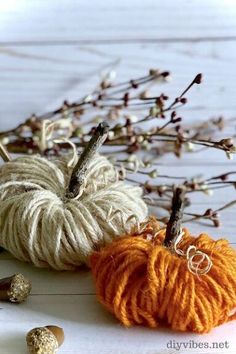 yarn pumpkins are sitting on top of each other with the words, diy fall twine pumpkins