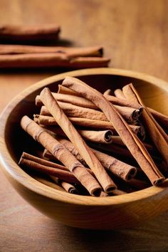 cinnamon sticks in a wooden bowl on a table