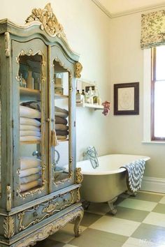 a bathroom with a claw foot bathtub next to a window