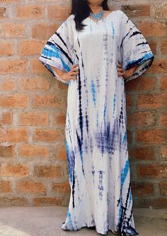 "All dresses are custommade- ONLY FOR YOU! Kaftan,RAYON Caftan, Long Robe, Summer Dress, Long Maxi, Loungewear, beachwear, Maternity Dress, Holiday, Vacation Wear The beauty of this kaftan is - -This lovely tie-dyed Indian kaftan is perfect for the poolside, beach or cruise holiday , anniversary gifts or as lounge wear. -It is Blue-turquoise-white-Indian hand tie-dyed - as pictured. Measurements- High quality soft rayon- not transparent! Width- Chest:waist: Hips - 68 inches around - FITS UPTO US Bohemian Abaya With Kimono Sleeves For Vacation, Bohemian Long Abaya For Beach Cover-up, Traditional Long Abaya For The Beach, Traditional Long Abaya For Beach, Beach Abaya Free Size Maxi Length, Beach Abaya In Maxi Length, Beach Tunic Abaya Free Size, Bohemian Floor-length Batik Maxi Dress, Bohemian Floor-length Maxi Dress With Batik Print