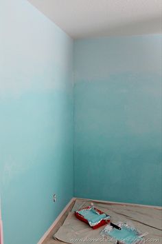 an empty room with blue walls and white paint