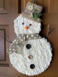 a snowman made out of fake fur and buttons