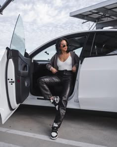 a woman sitting in the driver's seat of a car