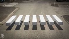 a crosswalk painted in black and white on the side of an empty parking lot