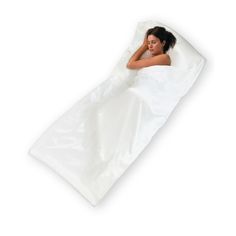 a woman laying on top of a white sheet