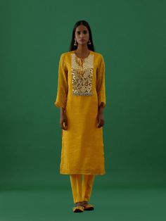 One of our timeless classics, hand-stitched exclusively for your bespoke taste. Channel your desi diva vibes and experience luxury in our all-time favourite festive collection comprising a Yellow Mirror Work Chanderi Tissue Silk Kurta. It comes with mirror work and ghungroo detailing on the yoke, a round neck with tie-up, and quarter sleeves. Fabric: Chanderi Silk Color: Yellow Note: Available in other colors The bottom and dupatta shown in the image are not included with the kurta. Bottom and d Yellow Mirror, Yellow Mirrors, Georgette Dupatta, 5 Elements, Straight Fit Pants, Yellow Satin, Silk Kurta, Festive Collection, Dupatta Set