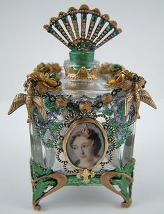 an ornate glass box with a woman's face on it