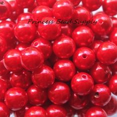 some red beads are sitting on a white surface and there is the words princess beat supply