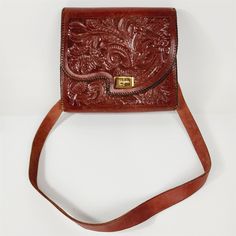 Handbag is in good preowned condition, normal vintage wear, some wear and scuff marks. It measures 10" wide x 8 1/2" tall x 3" deep. Please see pictures for details. Vintage Hand-tooled Crossbody Shoulder Bag, Retro Hand Tooled Shoulder Bag For Travel, Vintage Hand-tooled Crossbody Satchel, Vintage Hand Tooled Satchel For Daily Use, Retro Hand-tooled Satchel Shoulder Bag, Retro Hand Tooled Satchel Shoulder Bag, Vintage Crossbody Satchel For Daily Use, Vintage Crossbody Satchel For Formal Occasions, Vintage Formal Crossbody Satchel