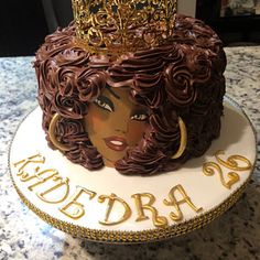 there is a cake that has been decorated with a woman's face and crown