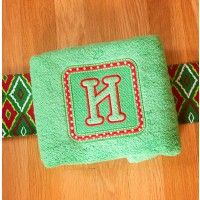 a green towel sitting on top of a wooden floor