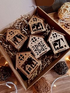 a box filled with wooden ornaments on top of a table next to string lights and twine