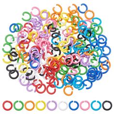 many different colored plastic rings on a white background