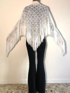 Lovely boho beauty fringe-tactic hand knit crochet triangular scarf from the 1970's. Hand crochet by a talented knitter this scarf is perfect for keeping you warm and bringing some light to the dark winter days. I love a white scarf in the dreary winter! Very delicate crochet - like a white spiderweb. Hand crochet in a wonderful open knit pattern. Wear this at the beach in winter, in front of a fire during chilly spring nights and for keeping warm at a festival. Great Stevie Nicks style. Yarn is Bohemian Festival Hand Knitted Shawl, Bohemian Hand Knitted Shawl For Festival, White Bohemian Shawl With Fringe, Bohemian White Shawl With Fringe, Winter Bohemian Shawl With Crochet Lace, Bohemian Shawl With Crochet Lace, Bohemian White Crochet Shawl, Bohemian Crochet Lace Shawl For Winter, Winter Bohemian Crochet Lace Shawl