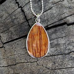 "Pendant size: 41mm x 24mm Thickness: 3mm Metal: Rhodium Plated on Brass Material: Genuine Hawaiian Koa Wood 18\" Silver-Colored Box Chain Included" Hawaiian Necklace, Hawaii Jewelry, Koa Wood, Silver Wedding Rings, Teardrop Necklace, Design Jewelry, Colourful Necklace, Brass Pendant, Pendant Design