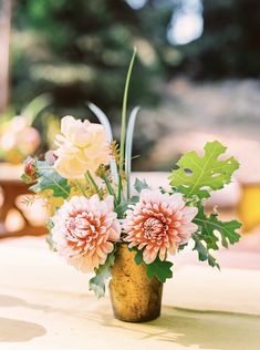 a vase filled with flowers sitting on top of a table