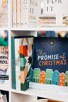 books on a shelf in a bookstore with the title'the promise of christmas '