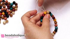 someone is making beaded bracelets out of wood beads