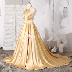 Backless Satin Halter Dress For Wedding, Gold Satin Evening Dress For Gala, Gold Satin Evening Dress, Halter Neck Satin Dress For Prom, Halter Neck Satin Prom Dress, Backless Satin Finish Halter Dress For Prom, Gold Satin Prom Evening Dress, Gold Satin Evening Dress For Prom, Satin Halter Neck Evening Dress With Satin Finish