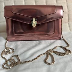 Never Used. Condition Exactly As Pictures Show. Chain Is Removable. Height: 5.5" Depth: 2" Width: 8" Shoulder Strap Drop: 23" Elegant Metallic Bag With Chain, Elegant Metallic Bags With Chain, Elegant Metallic Bag With Chain Strap, Elegant Metallic Bag As Gift, Elegant Metallic Bag For Gift, Elegant Metallic Bags For Gifts, As Pictures, Bvlgari Bags, Crossbody Bag