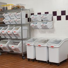 there are many bins and containers on the shelves next to each other in this room