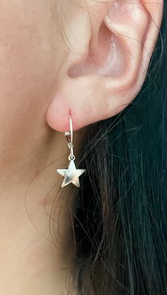 These silver star earrings are the perfect addition to any outfit! They can be great for everyday wear or for a occasion. I love these because they complete my look and add a extra pop to my outfit. I wear them to work, out, run errands and more. Seriously, you can't go wrong with these!! Any of your outfits need some shining through? These are calling your name! This listing is for one pair (1) of mini silver star charm earrings For extra protection of these earrings: - Please avoid contact with moisture for all jewelry. Apply lotions, sprays and perfumes before putting on jewelry. Take off jewelry before exercise and bed. Keeping your jewelry as dry as possible will help prolong the nature of its color and shine. - Store your jewelry when dry only. To clean jewelry, gently use a soft clo Everyday Hypoallergenic Star-shaped Jewelry, Everyday Hypoallergenic Star Jewelry, Star-shaped Earrings With Ear Wire For Everyday, Everyday Star Shaped Pierced Earrings, Everyday Drop Earrings With Star Charm, Minimalist Star-shaped Hoop Earrings For Pierced Ears, Elegant Star Shaped Nickel-free Hoop Earrings, Minimalist Star-shaped Hoop Earrings, Minimalist Star Shaped Hoop Earrings