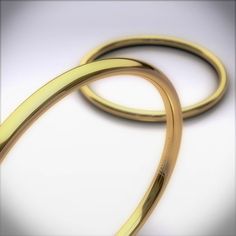 two shiny gold colored rings on a white background with space for text or image to be added