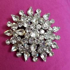 If you love jewelry, you will love this vintage glitzy crystal brooch which is probably from the 50's if not earlier.  It is a weighty, domed pin with clear round and pear shaped crystals that measures about 3 inches in diameter. These stones shine so much that it is hard to photograph them and the photos don't do them justice.  This pin is beautiful, and would look fabulous on a blazer, jacket or coat.        These are great for the vintage collector, or as a gift for someone who loves glitzy jewelry and is not afraid to be seen.  If you are shy, this pin is not for you, but if you love attention,  check out the other pins and brooches I have listed.  I guarantee that you will get noticed!   If you have any questions, please feel free to contact me and I will try to post more of my vintag Vintage Brooches Boylerpf Antique & Vintage Jewelry, Cheap Handmade Vintage Brooches, Cheap Round Brooch Jewelry, Cheap Round Brooches As Gifts, Luxury Vintage Pins For Women, Luxury Vintage Brooch Pins, Vintage Costume Jewelry Ornament, Cheap Silver Crystal Brooches, Affordable Silver Elegant Brooches