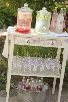 an outdoor bar cart with drinks on it