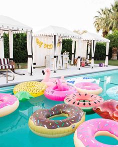 inflatable donuts and flamingos float around the pool