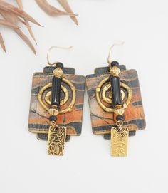 Listing is for a Vintage Artisan Chinese safari print bronze architectural tribal earrings.  Very nicely made earrings with black onyx? accent and dangle drop Chinese hieroglyph symbol. Earrings have safari print, bronze and paper coated with paint. Earrings measure 2.4" x 0.9".  Good vintage condition! thank you. (N132) Artistic Black Jewelry With Matching Earrings, Artistic Black Drop Earrings, Artistic Black Dangle Jewelry, Artisan Black Jewelry With Ear Wire, Artistic Black Dangle Earrings, Black Earrings With Artistic Design For Gift, Black Earrings With Artistic Design As A Gift, Artisan Black Dangle Earrings, Black Artisan Earrings