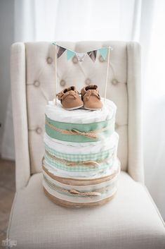 a baby's first birthday cake is stacked on top of the other tiers