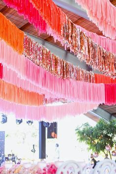 there are many colorful streamers hanging from the ceiling